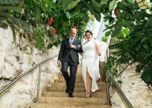 Dad walking bride down the isle at the Cockrell Butterfly Center